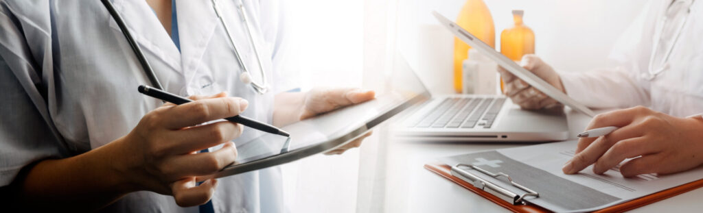 Medicine doctor hand working on a patients x-ray scans digital healthcare and connection with modern virtual screen interface icons, Medical technology and network concept.